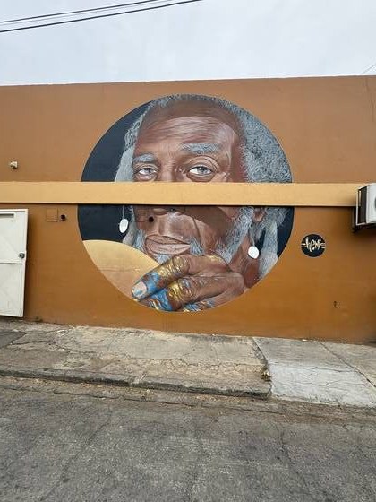 Mural of an elder painted on a San Nicolas wall